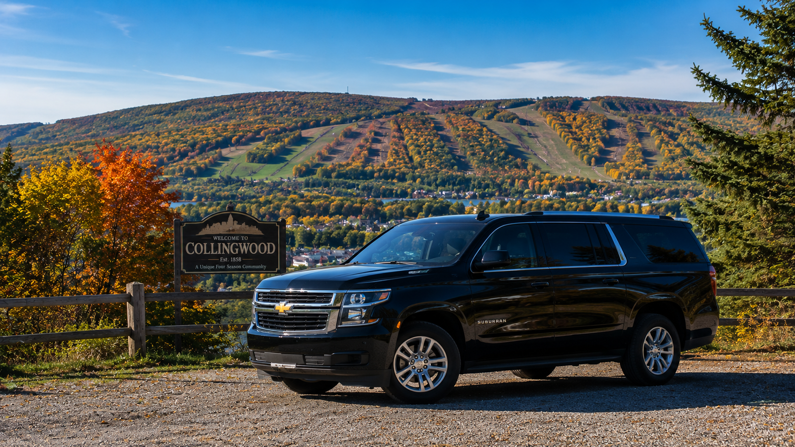 Black executive SUV limo parked against the backdrop of Collingwood hills.