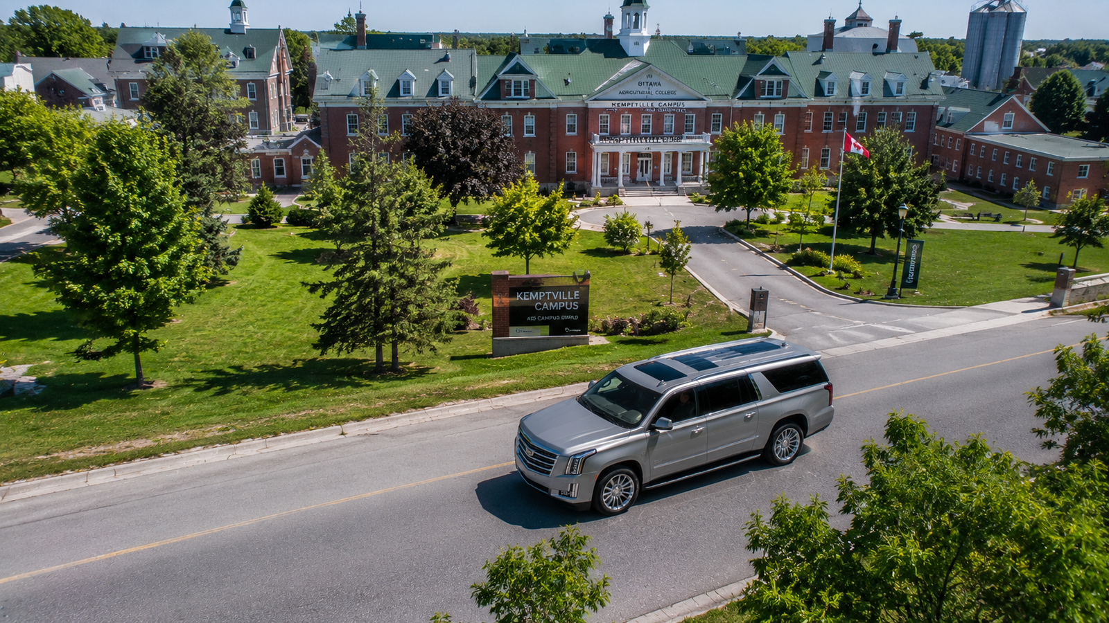 Silver luxury SUV limo driving past historic heritage buildings in Kemptville.