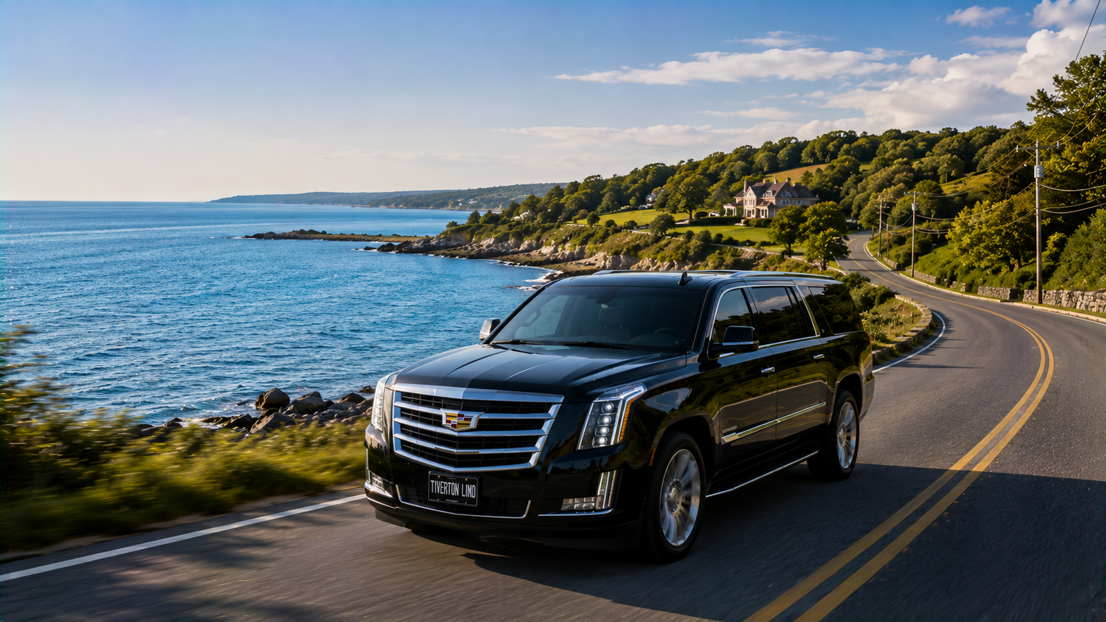 Silver luxury SUV limo driving along a coastal road near Tiverton.